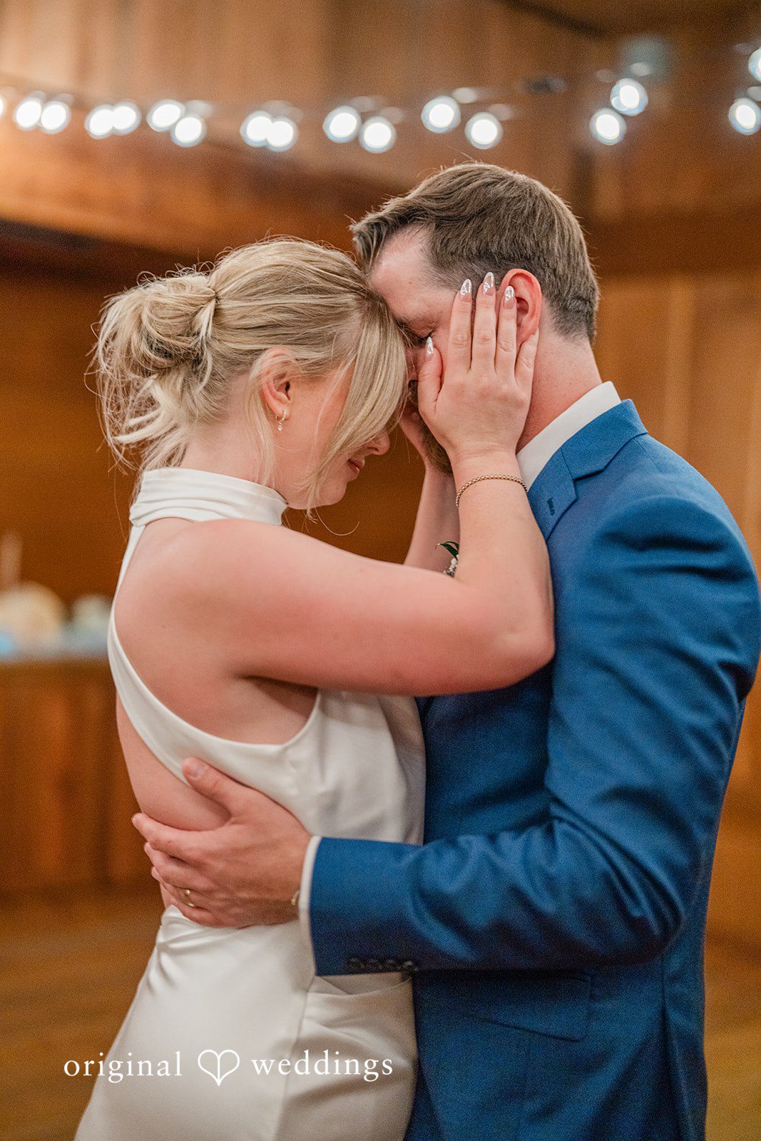 Destiny + Maksim A close-up portrait of a bride and groom embracing closely on the dance floor.