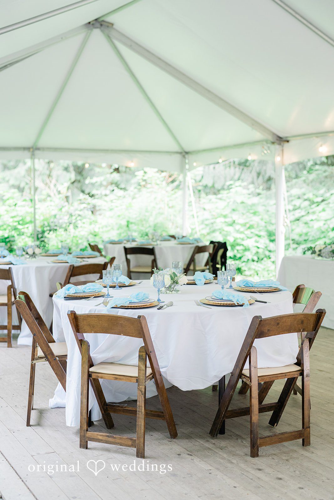 Destiny + Maksim A set wedding reception table underneath a white canopy tent.