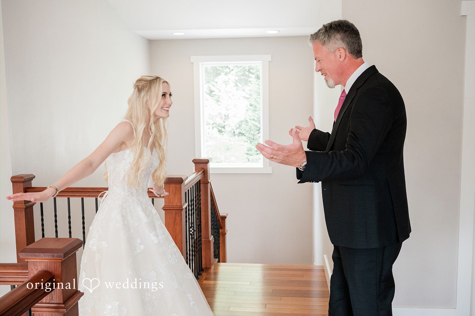 Luke + Kelsey A bride walking down a wooden staircase toward a man.