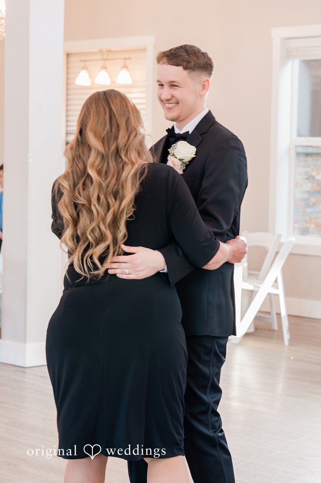 Luke + Kelsey A groom dancing with a guest at a reception.
