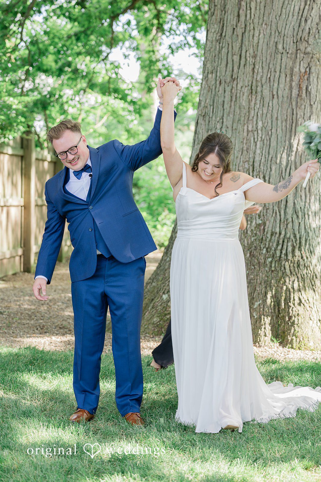 Emily + Joshua Bride and groom walking hand in hand after their wedding ceremony.