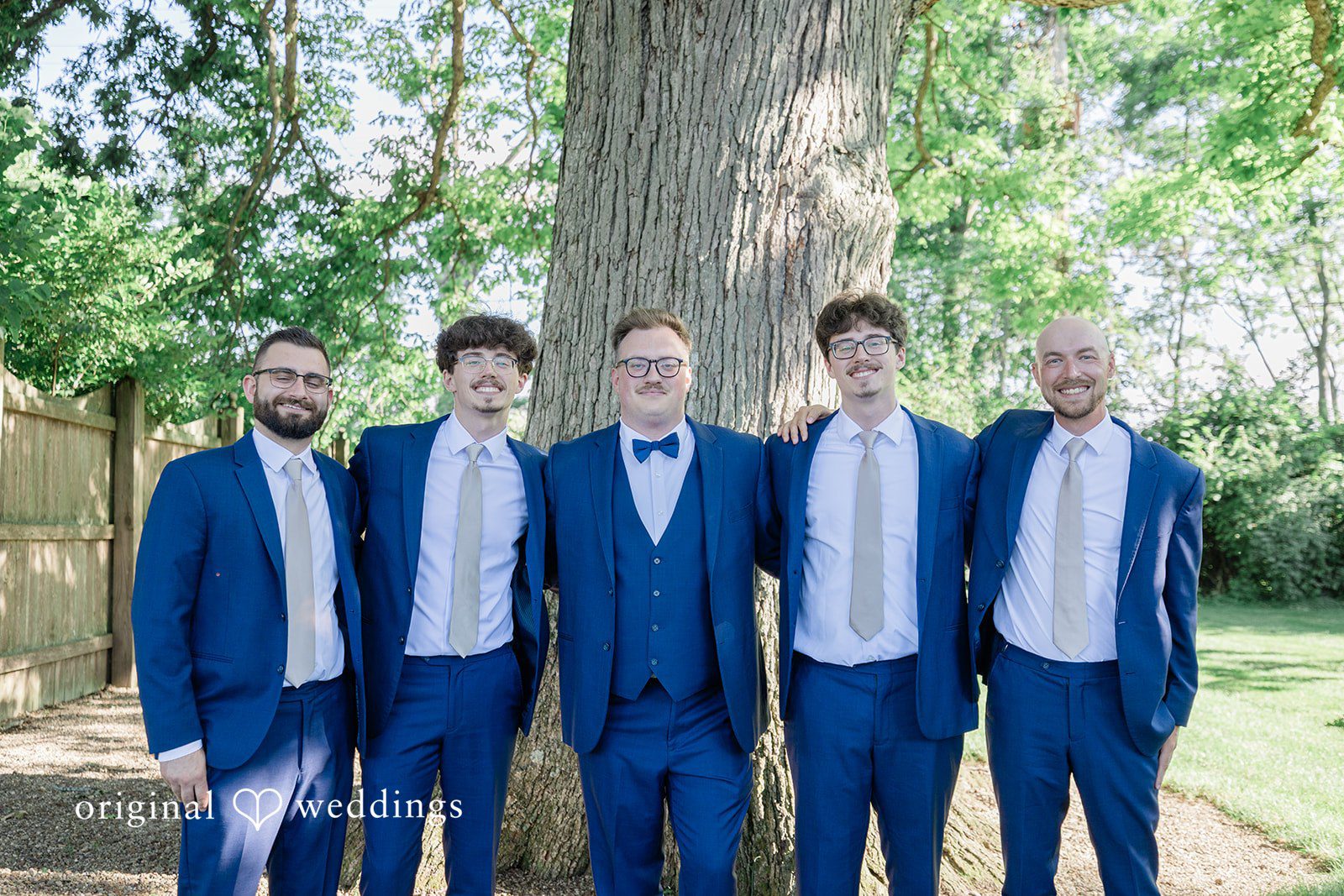 Emily + Joshua Groom smiling alongside his groomsmen before the wedding ceremony.