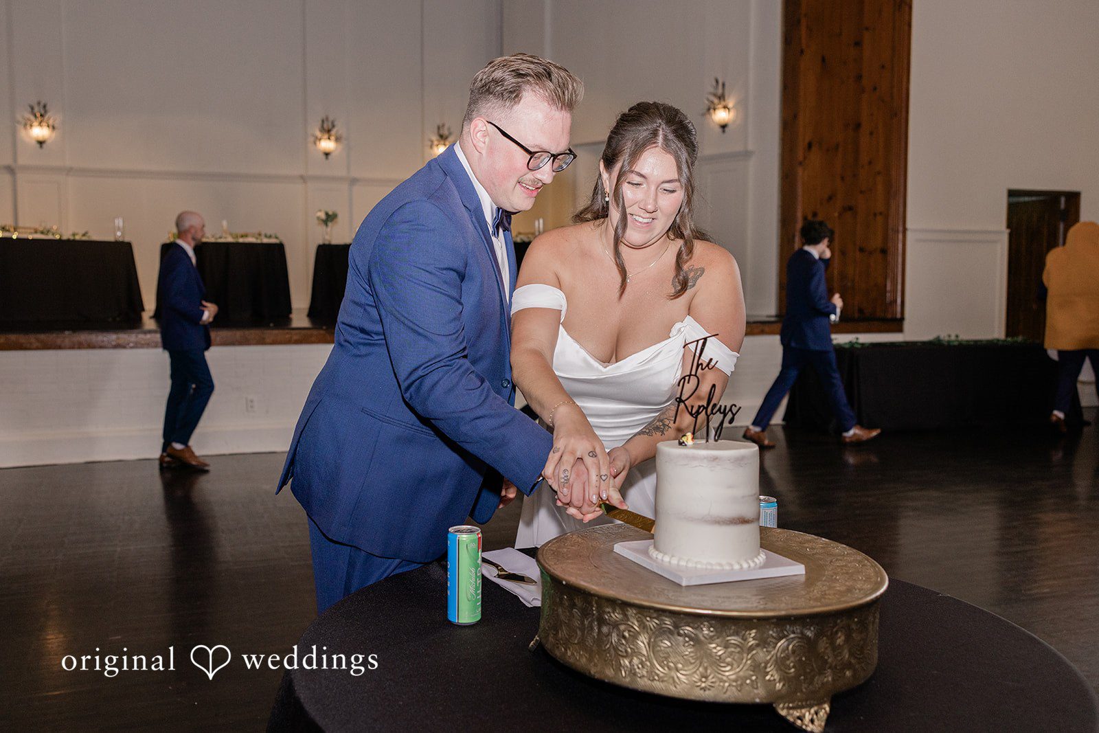 Emily + Joshua Newlyweds sharing a joyful cake-cutting moment at Whitehall Columbia.