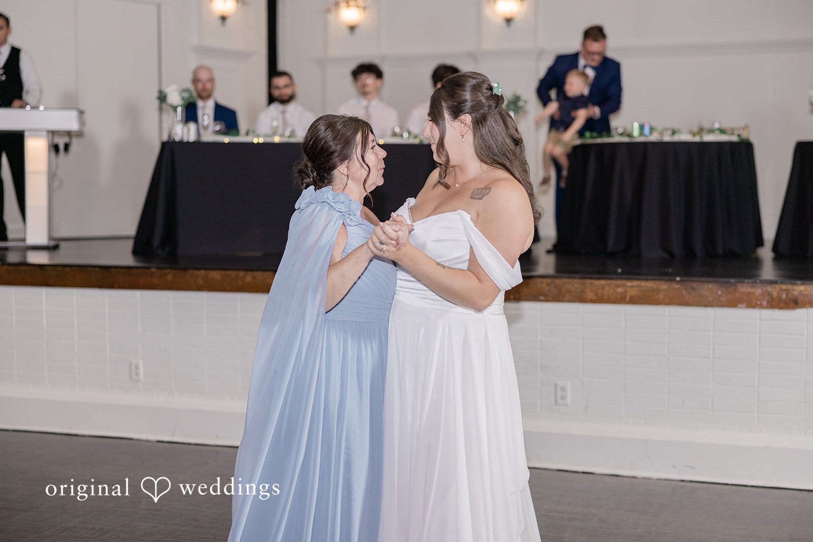 Emily + Joshua Bride sharing a joyful dance with a loved one during the reception.