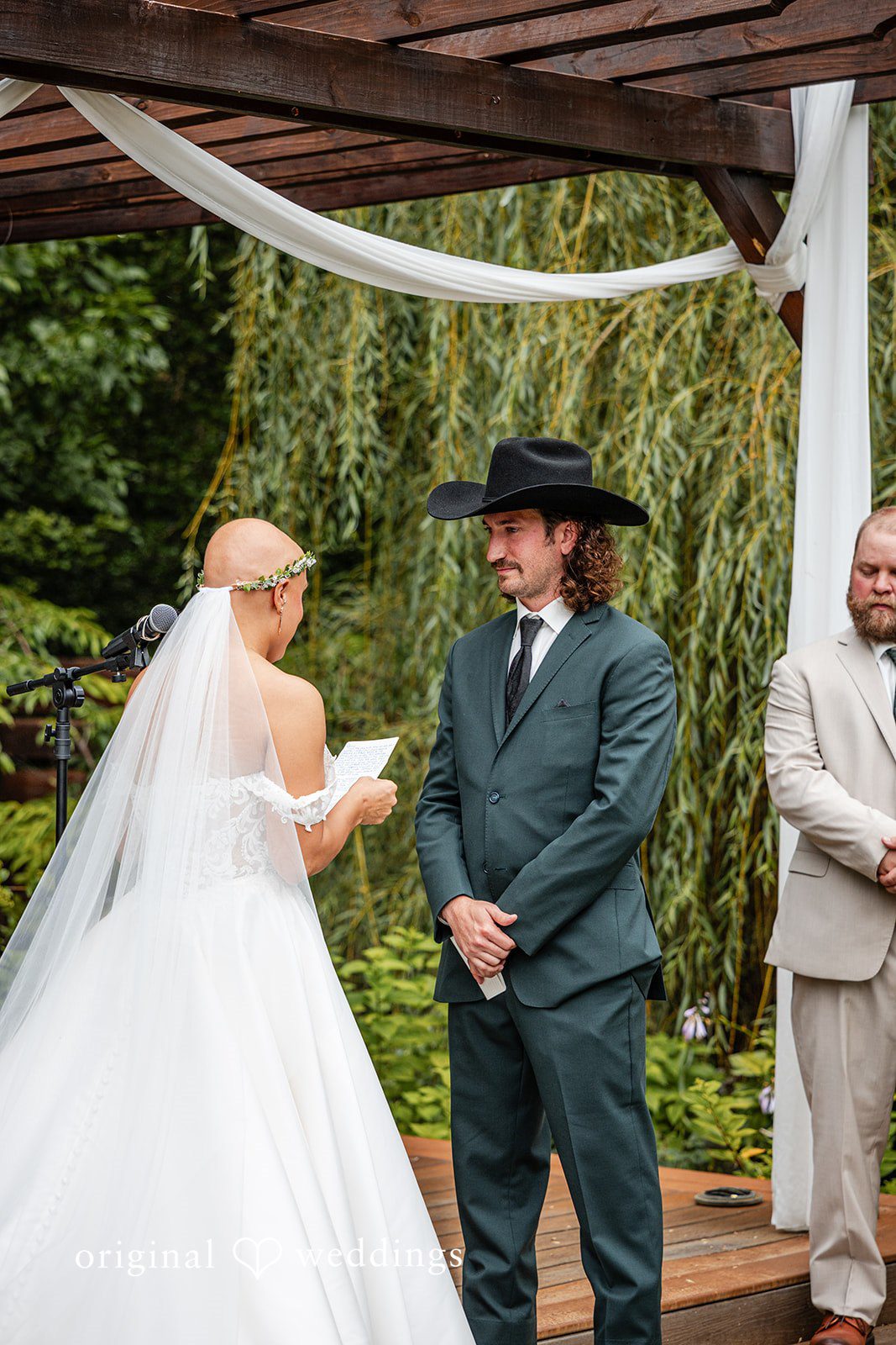 Savannah + Phillip A bride and groom facing each other at the altar while exchanging vows.