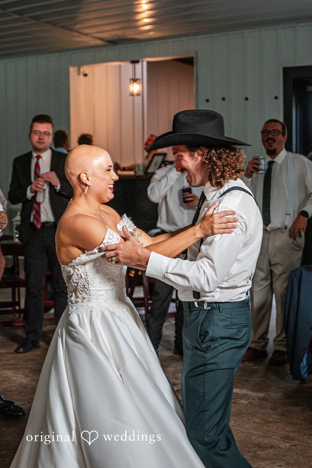 Savannah + Phillip A bride and groom dancing together at their reception while surrounded by wedding guests.