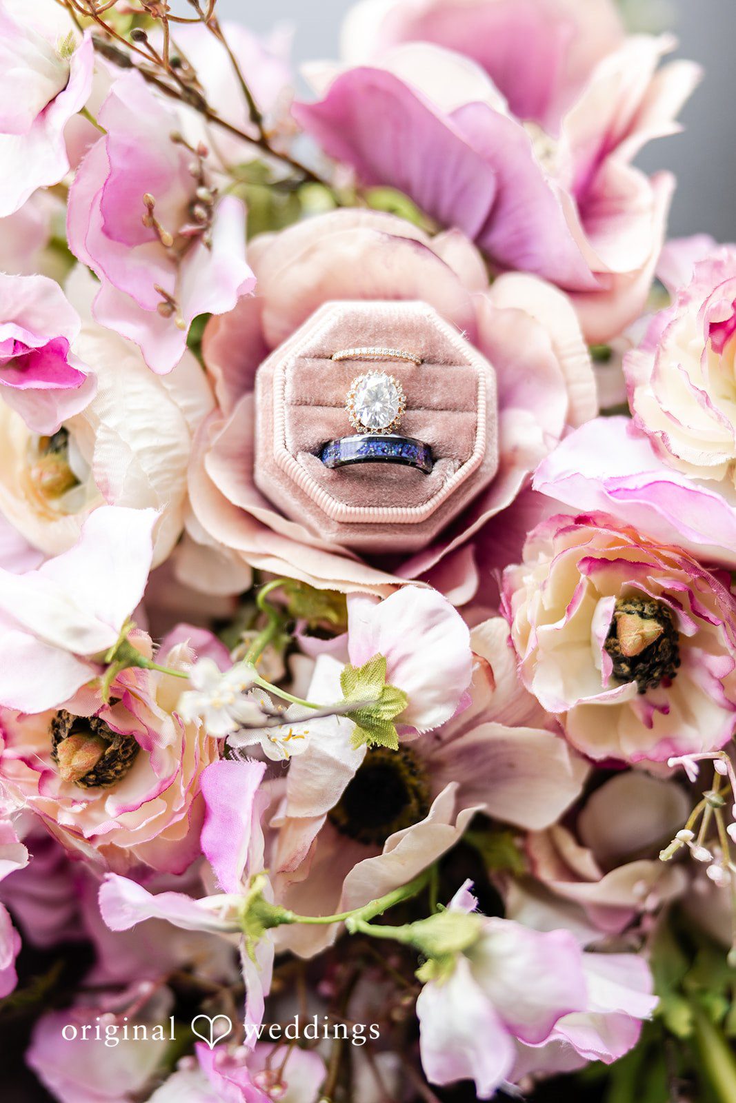 Dan + Alex A close-up view of a bridal bouquet filled with pink, blush, and purple roses.