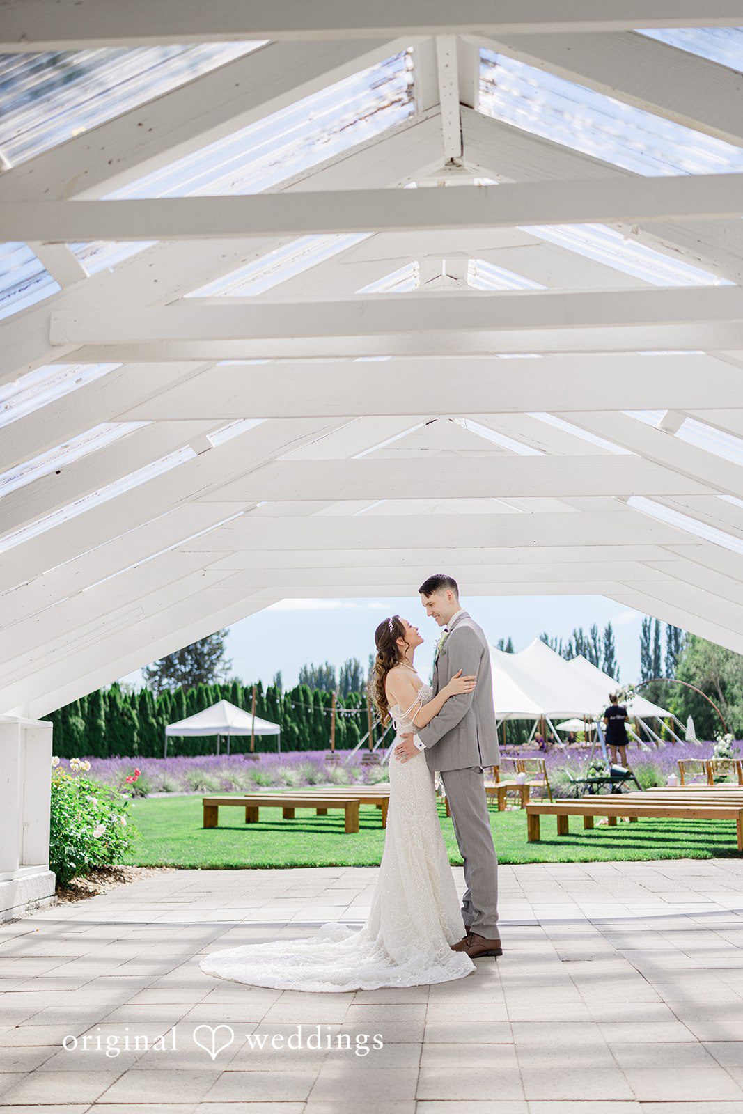 Veronica + Andrew A wedding couple slow-dances alone under a large white event structure.