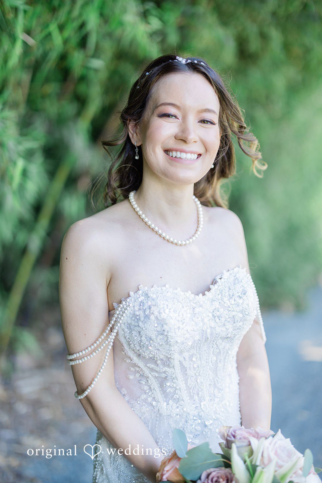Veronica + Andrew A smiling bride in a white wedding gown holding her bridal bouquet.