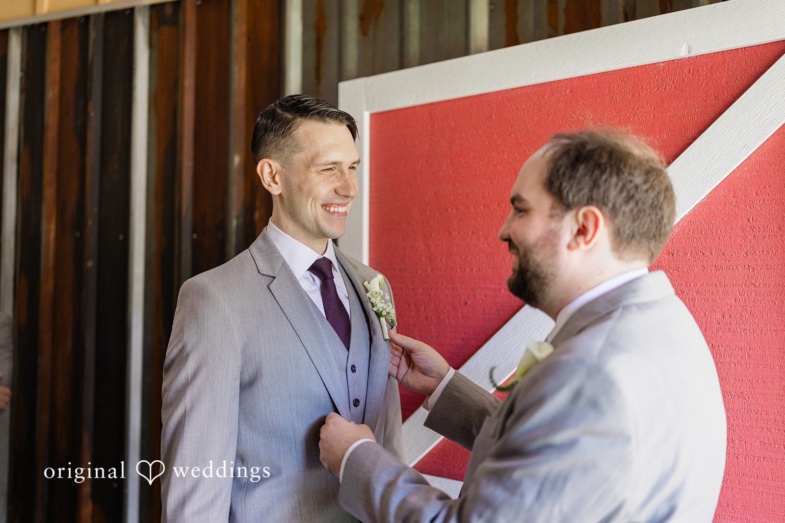 Veronica + Andrew A groom receiving assistance with his suit jacket from another man.