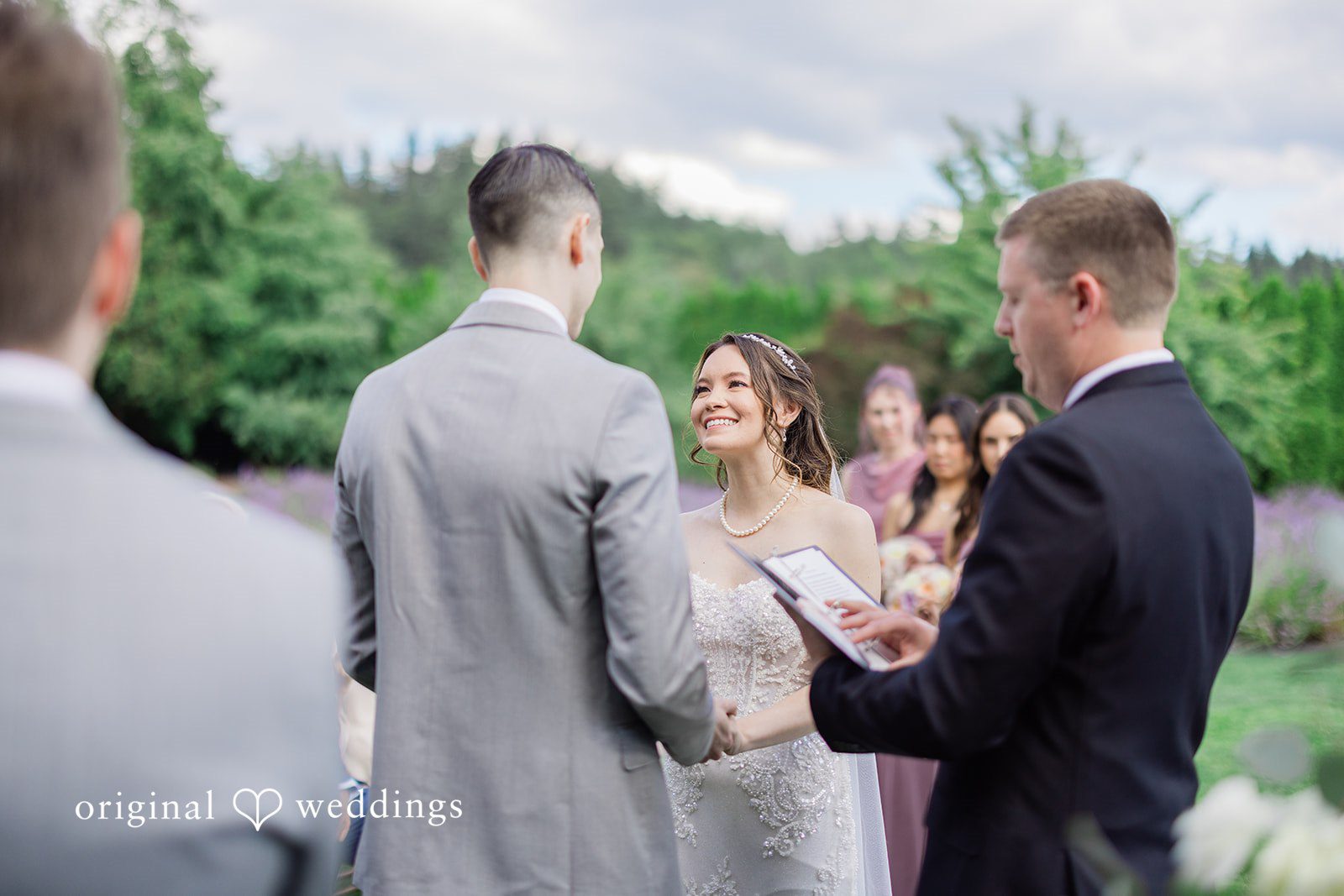 Veronica + Andrew A wedding couple facing an officiant during their formal ceremony.