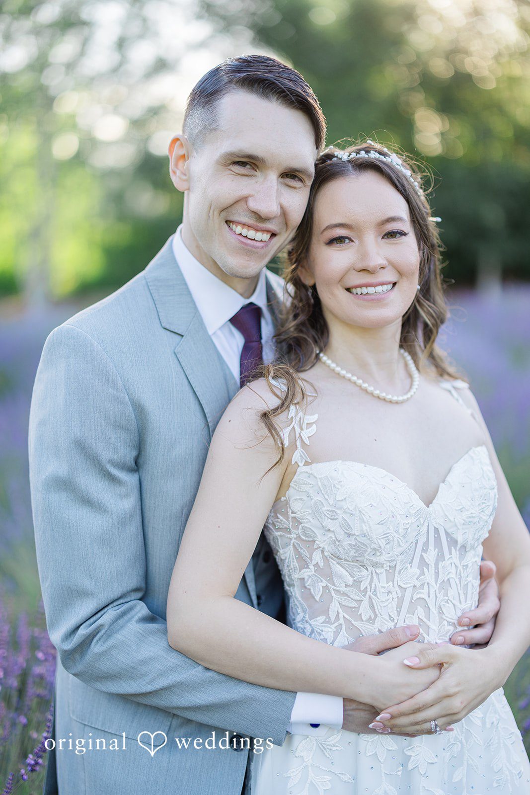 Veronica + Andrew A close-up portrait of a smiling bride and groom posing closely together.