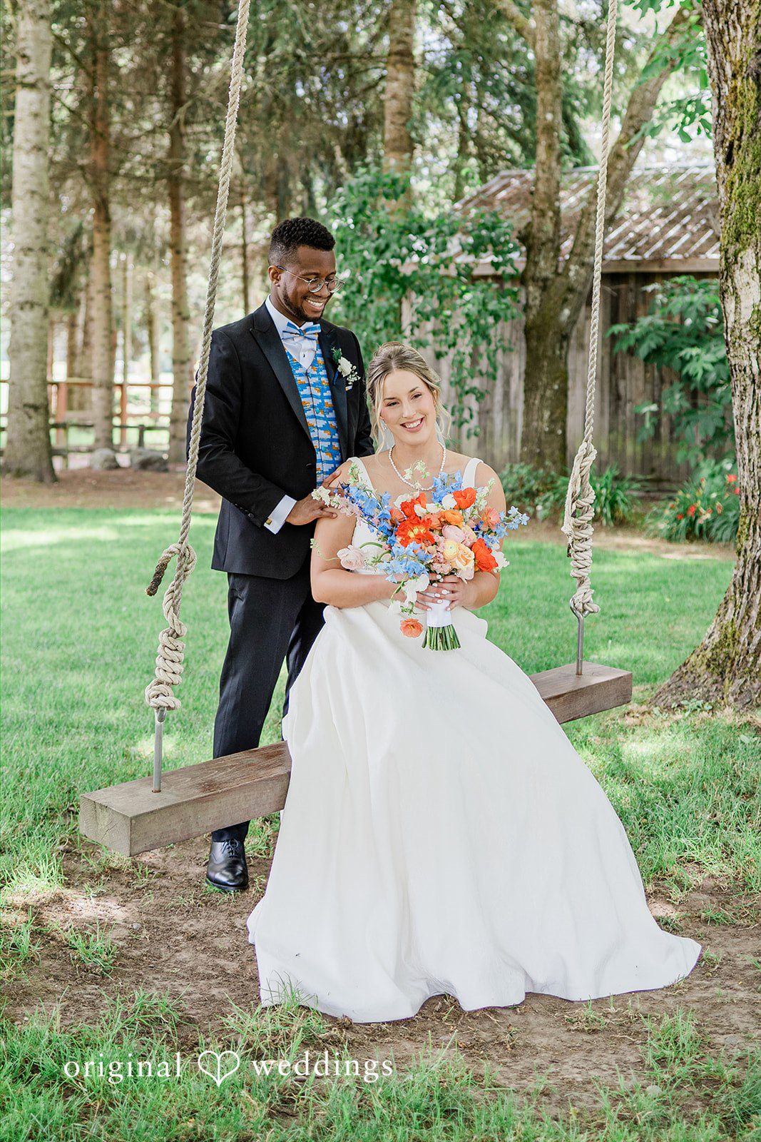 Katrina + Japhet Groom looking at the bride while the bride stands next to him in a grassy field.