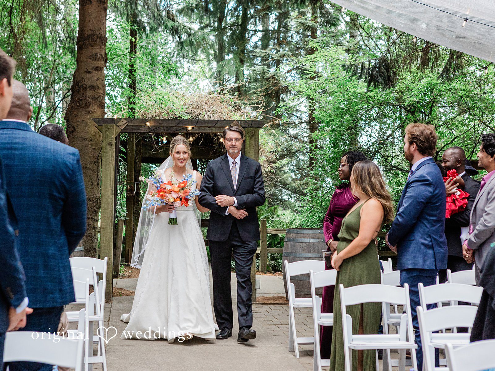 Katrina + Japhet Bride walking down a wedding aisle at Woodland Meadow Farms.