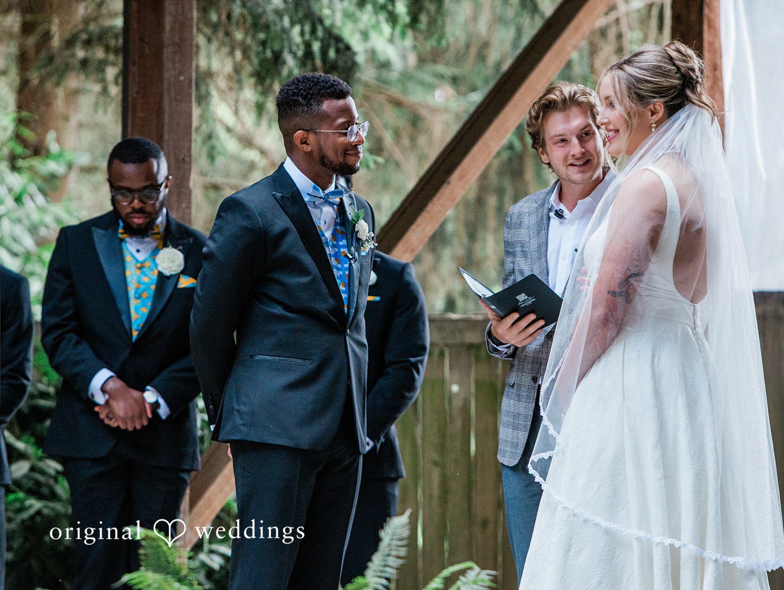 Katrina + Japhet Bride and groom looking at each other while standing together during their wedding ceremony.