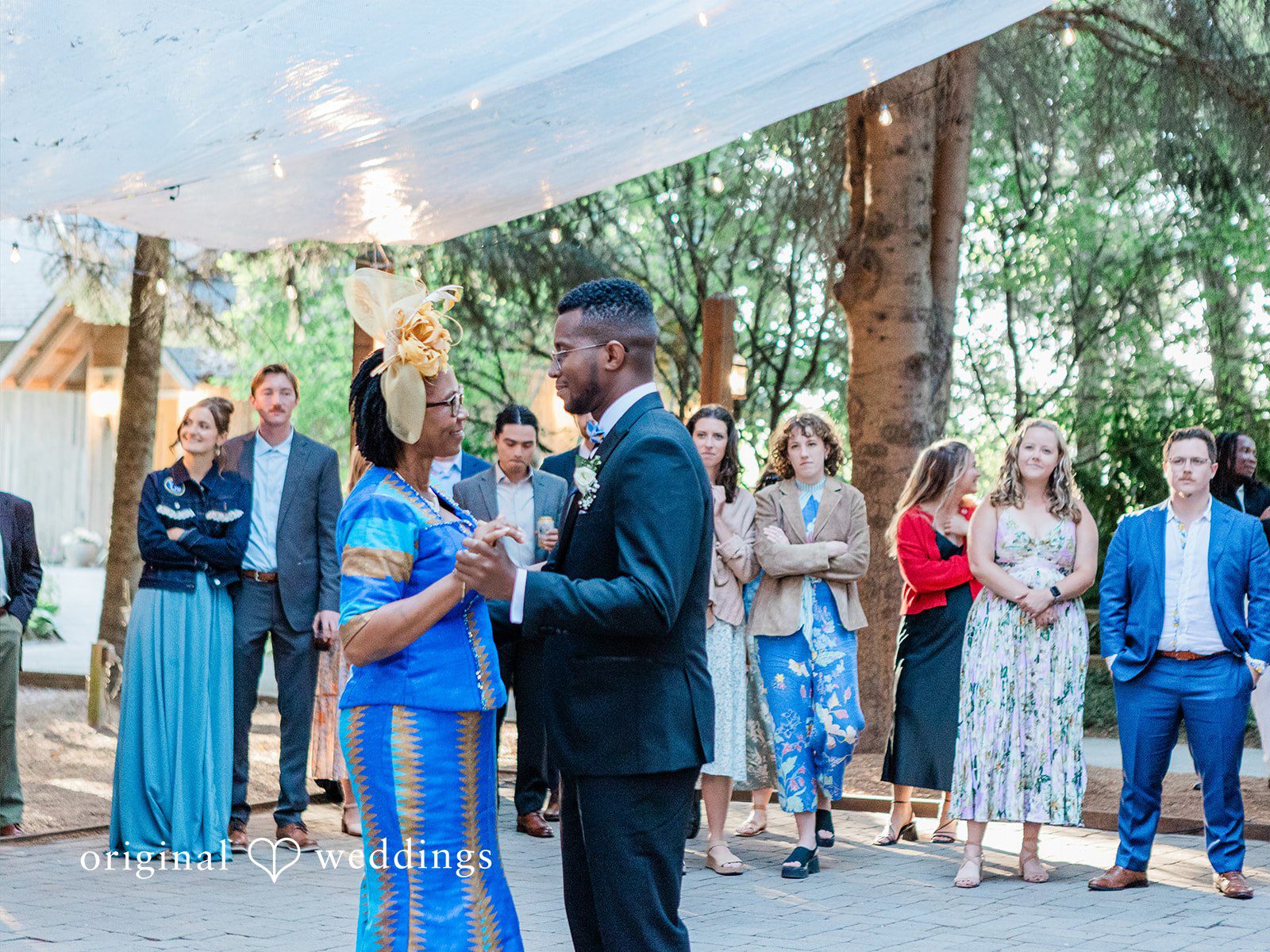 Katrina + Japhet Groom dancing with a woman in a dark dress on the dance floor.