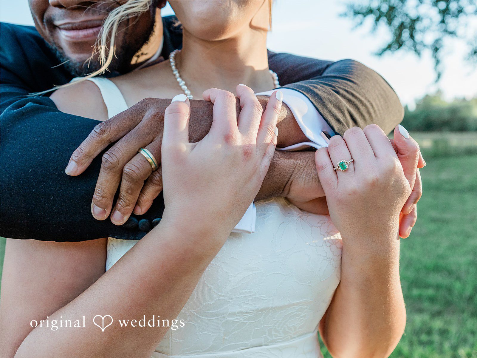 Katrina + Japhet Close-up view of a bride's hands resting on the groom's shoulders, showcasing the wedding ring.