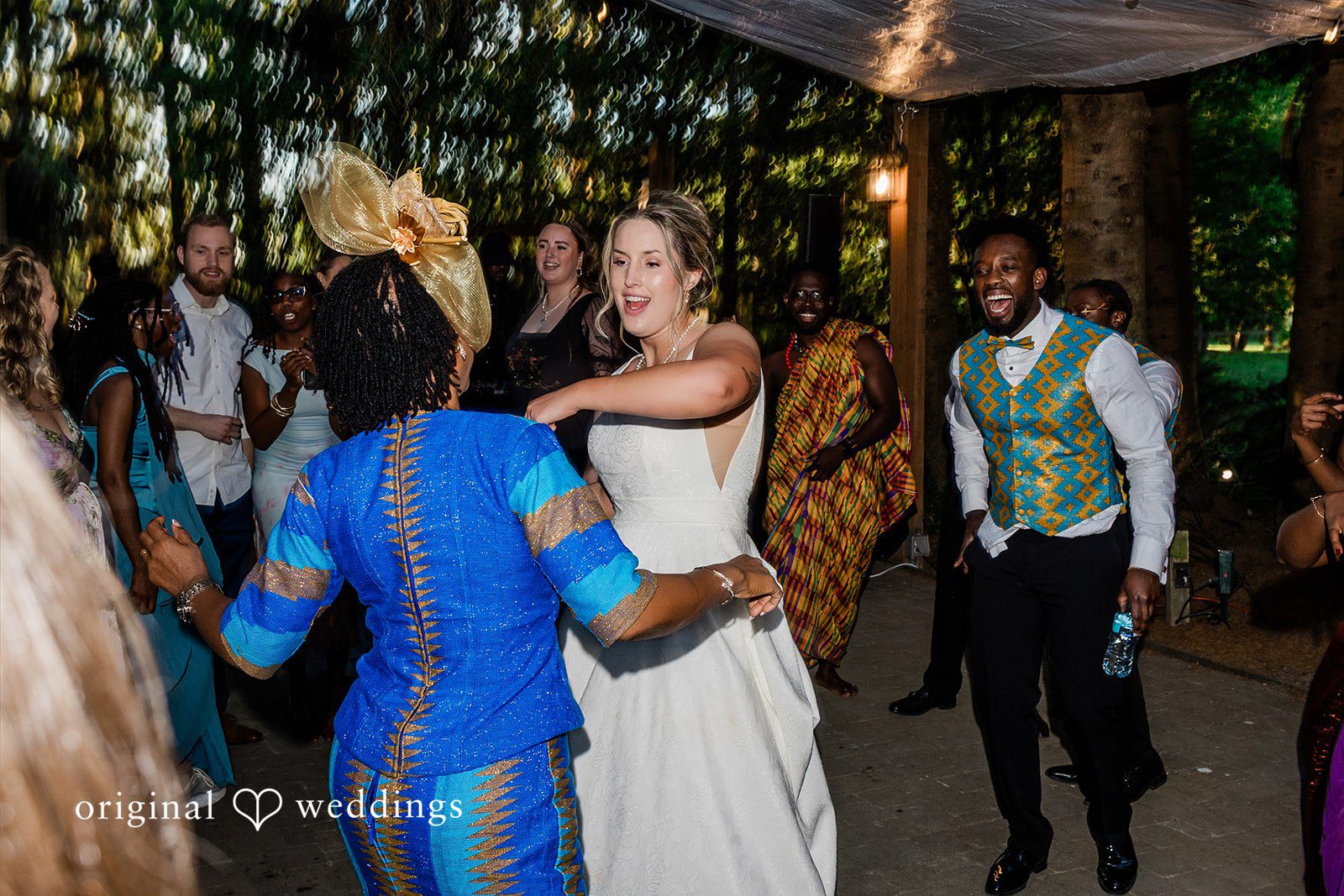 Katrina + Japhet Wedding guests dancing and enjoying the celebration on a lively reception dance floor.