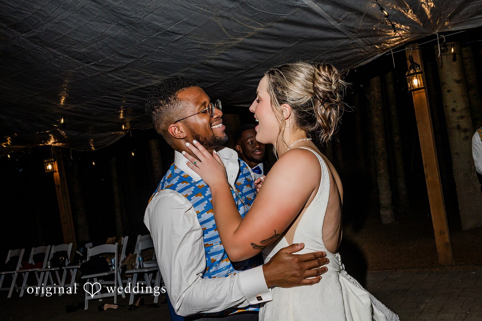 Katrina + Japhet Bride and groom smiling warmly at each other while dancing together closely on the dance floor.