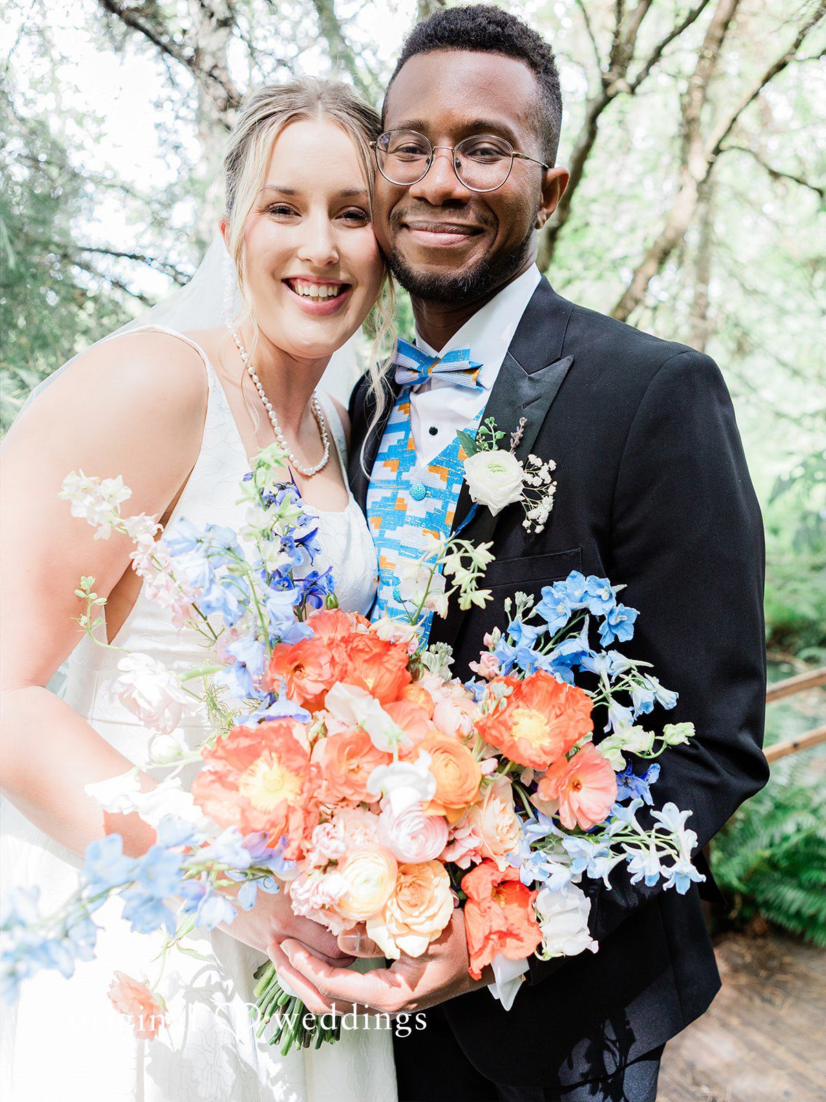 Katrina + Japhet Close-up portrait of a smiling bride and groom looking at each other.