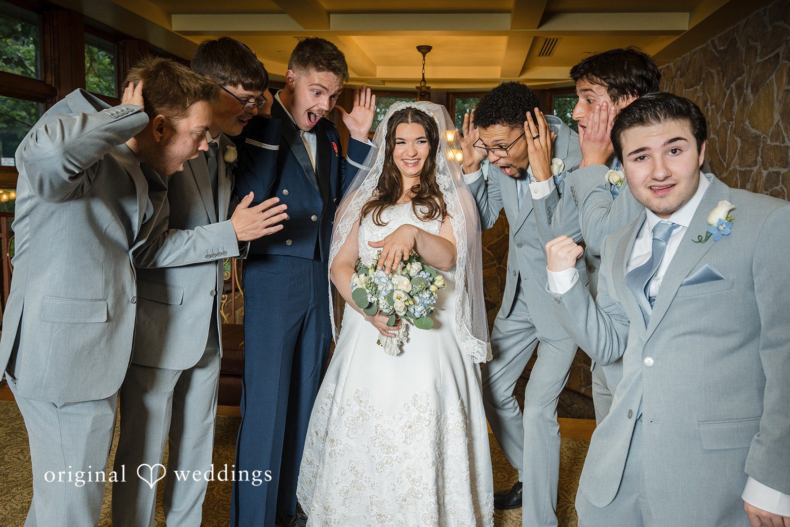 Ava + Zach A wedding party cheering and throwing petals as a newly married pair walks down the aisle.