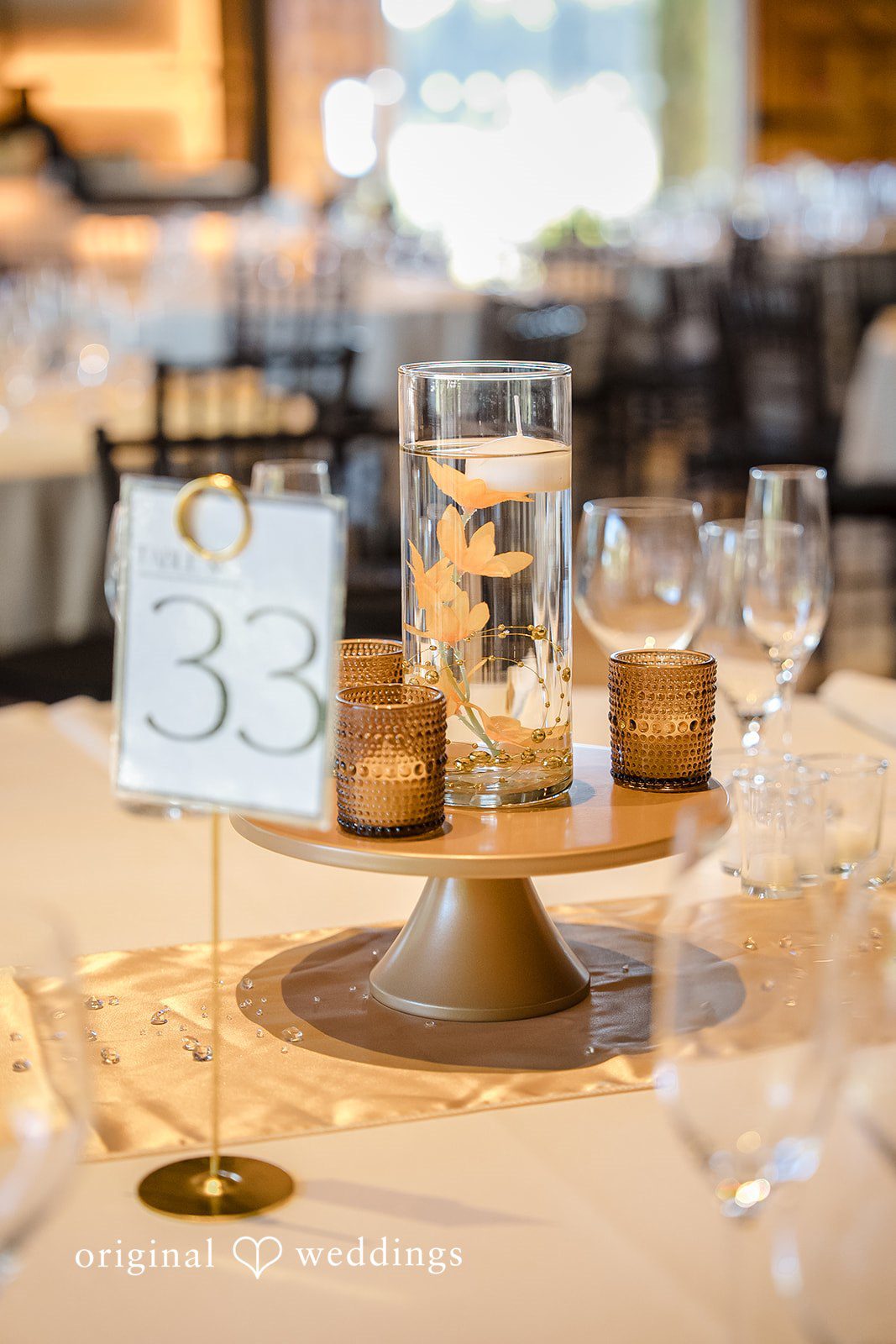 Kathir + Nandita A close-up of a rustic wedding centerpiece on a wooden table.