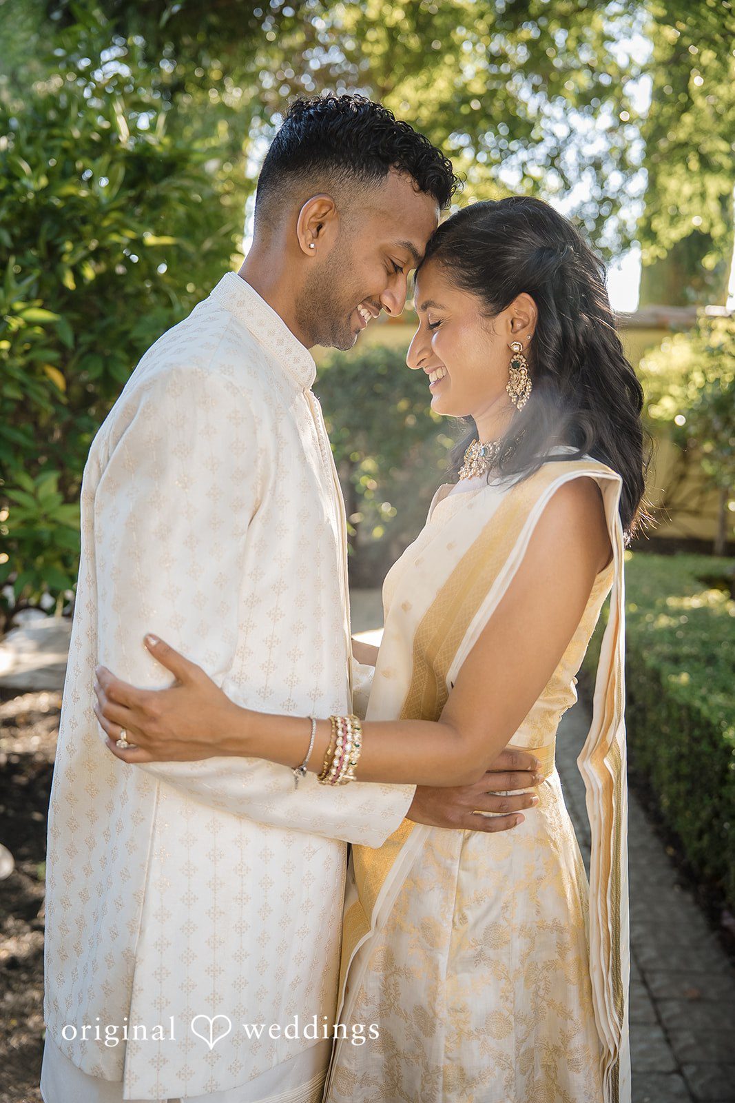 Kathir + Nandita A couple sharing a close, smiling look with a scenic background.