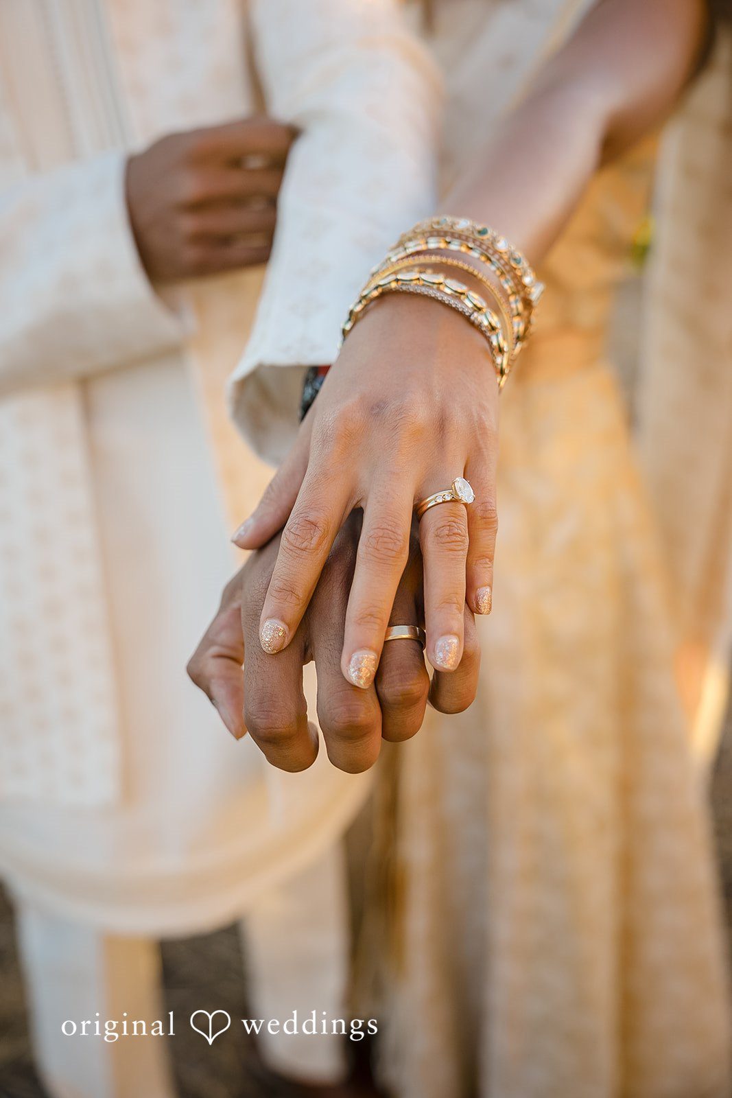 Kathir + Nandita A close-up view focused on a bride and groom holding hands