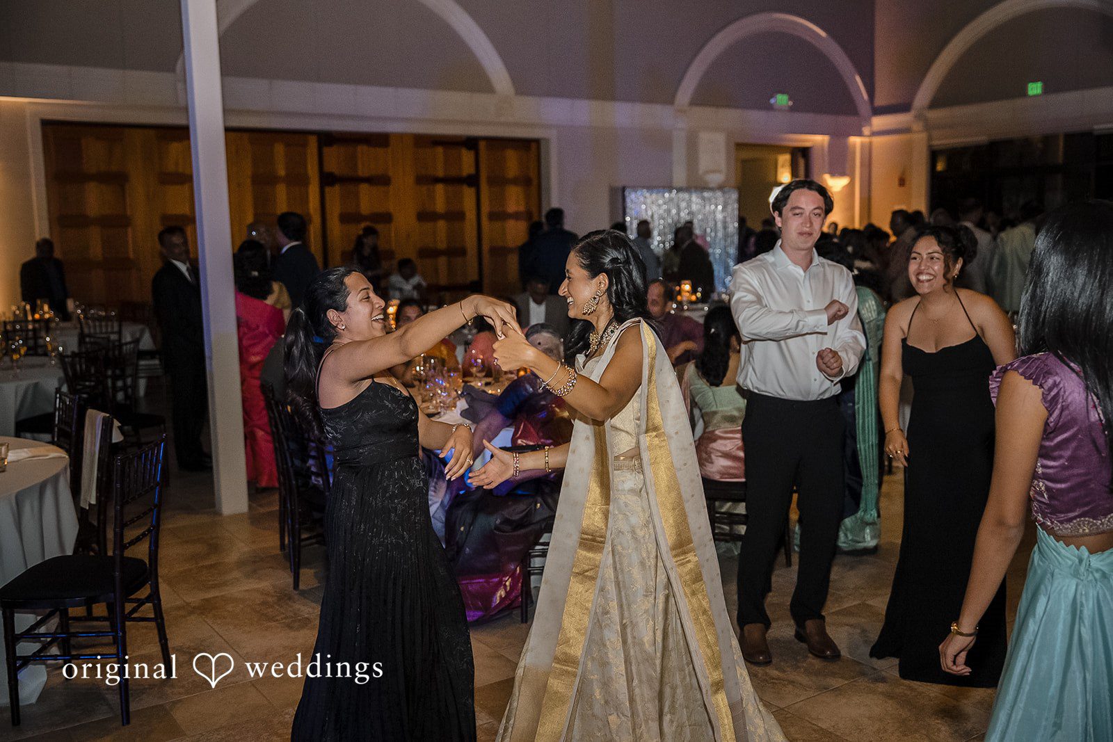 Kathir + Nandita Guests in formal attire dancing and celebrating at a festive reception party.