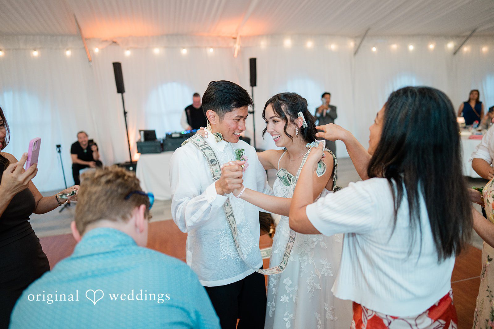 Katie + Gerald Wedding guests dancing and celebrating together on a crowded dance floor.