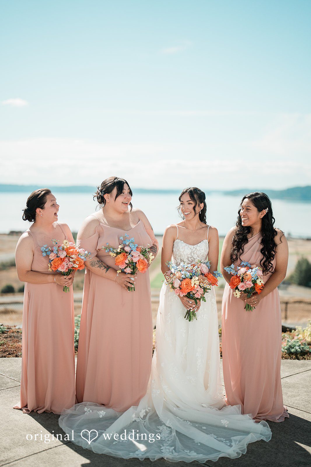 Katie + Gerald A bride standing with her bridesmaids who are wearing matching pink dresses.
