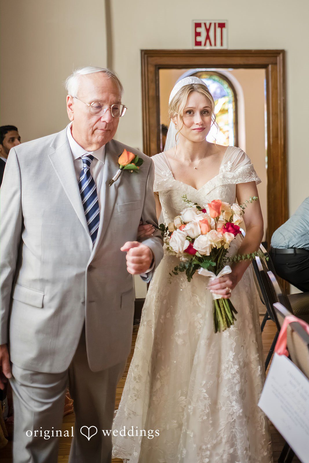 Julie + Joshua A bride walking down the church aisle alongside an older man in a gray suit.