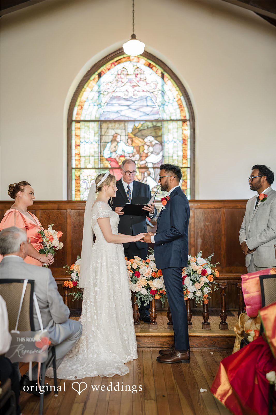 Julie + Joshua A bride and groom standing together at the church altar during their wedding ceremony.