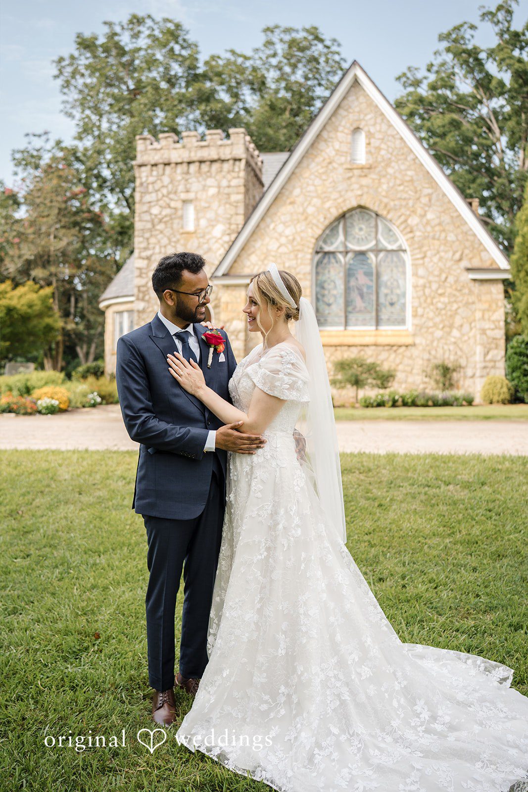 Julie + Joshua A bride and groom sharing a close moment with a stone church in the background.