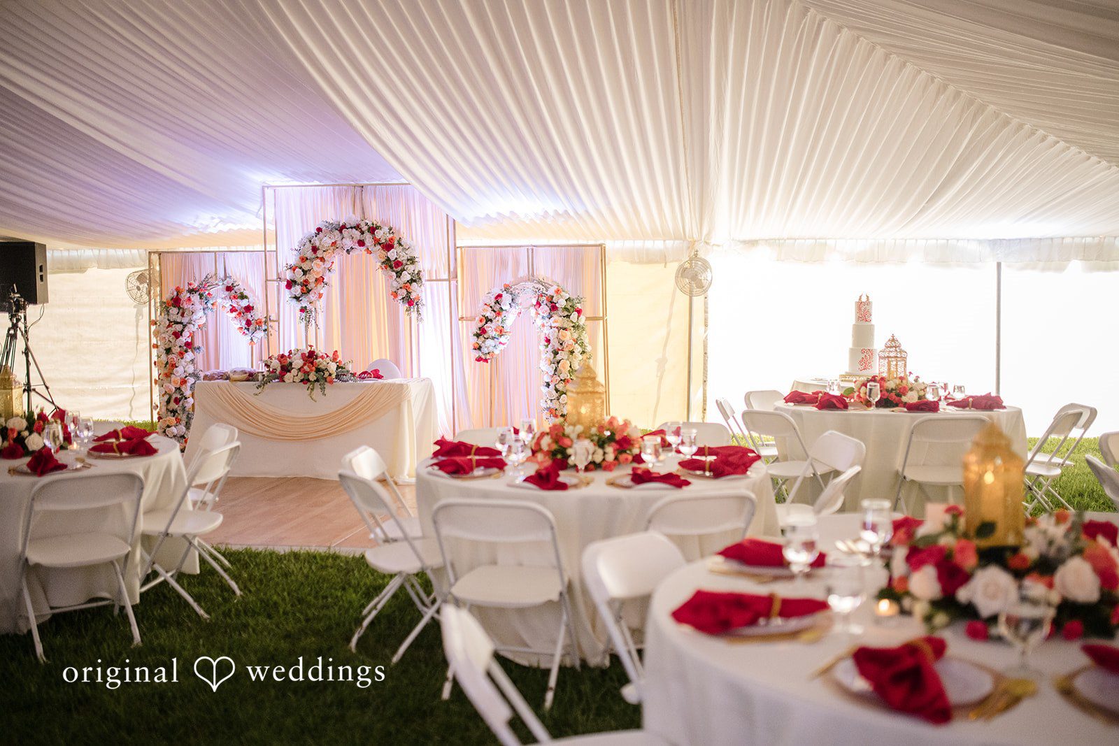 Julie + Joshua A close-up of a decorated table setting featuring floral arrangements and lighting elements.