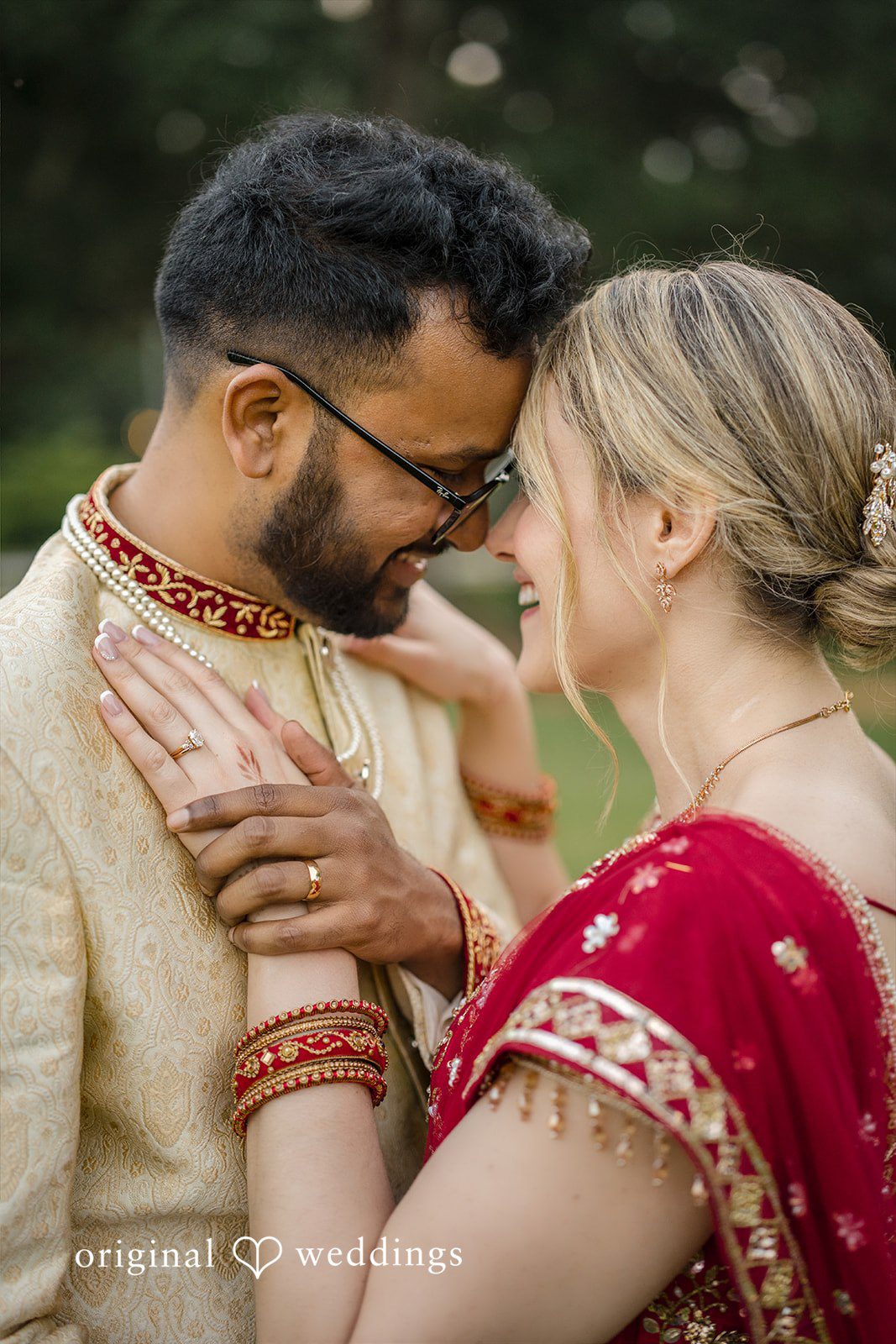 Julie + Joshua A groom embracing his bride closely while wearing traditional embroidered clothing.
