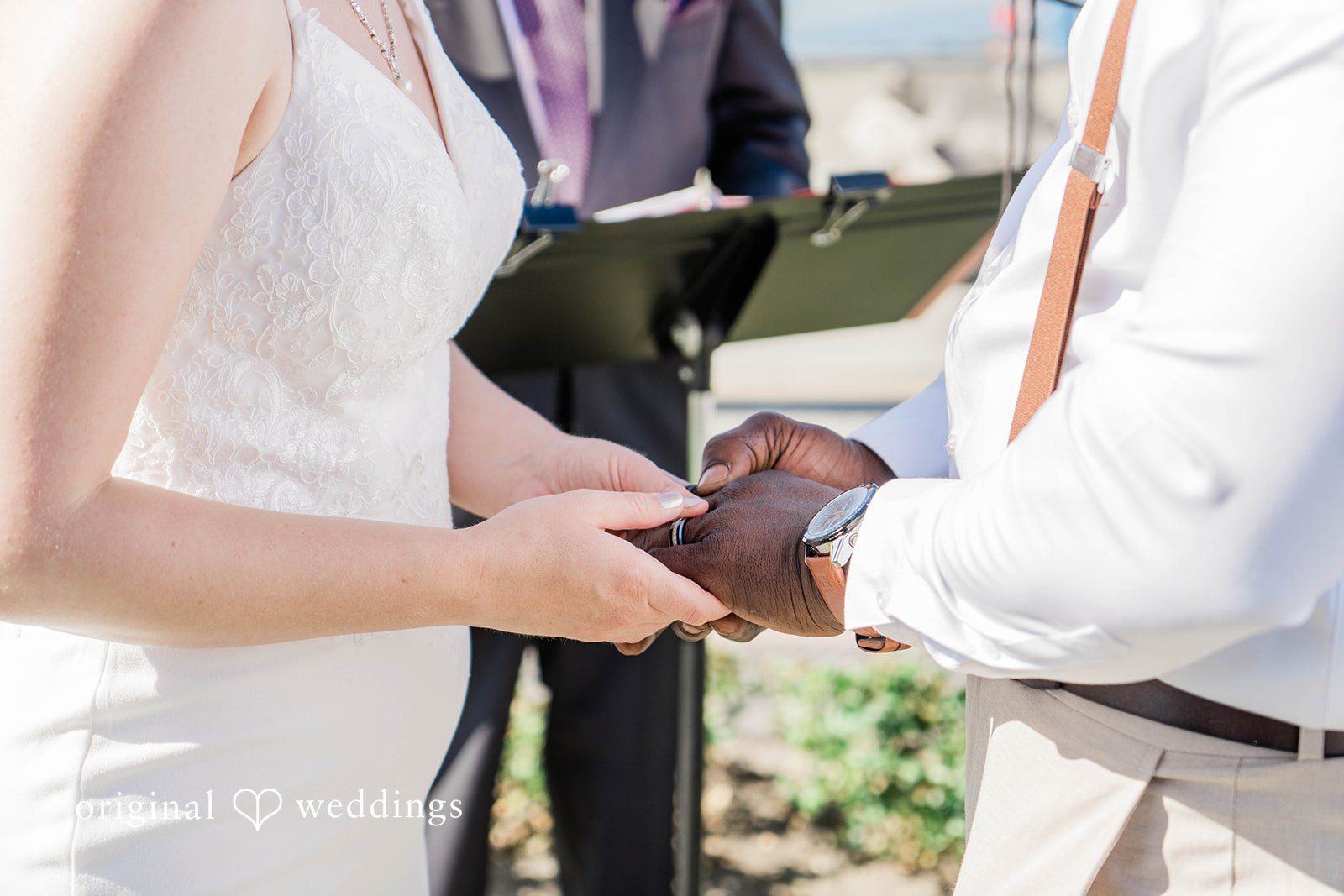 Naomi + Darrell Close-up of the bride and groom's hands during the ring exchange.