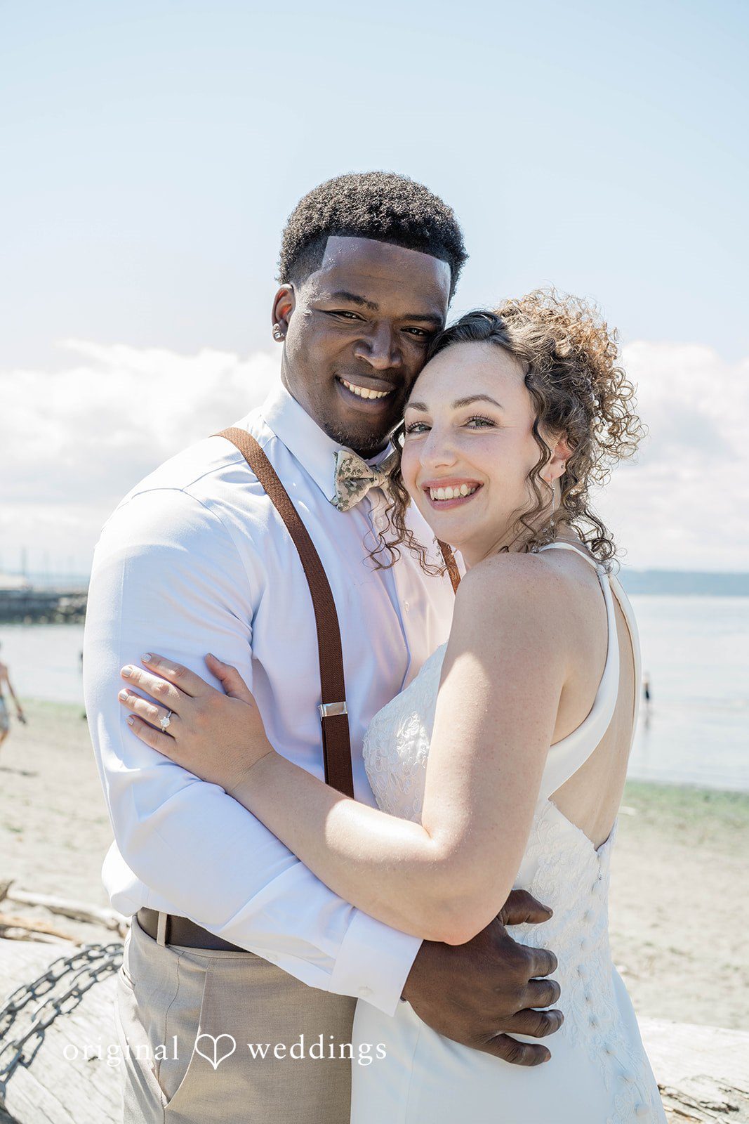 Naomi + Darrell Close-up portrait of the smiling bride and groom embracing tightly.