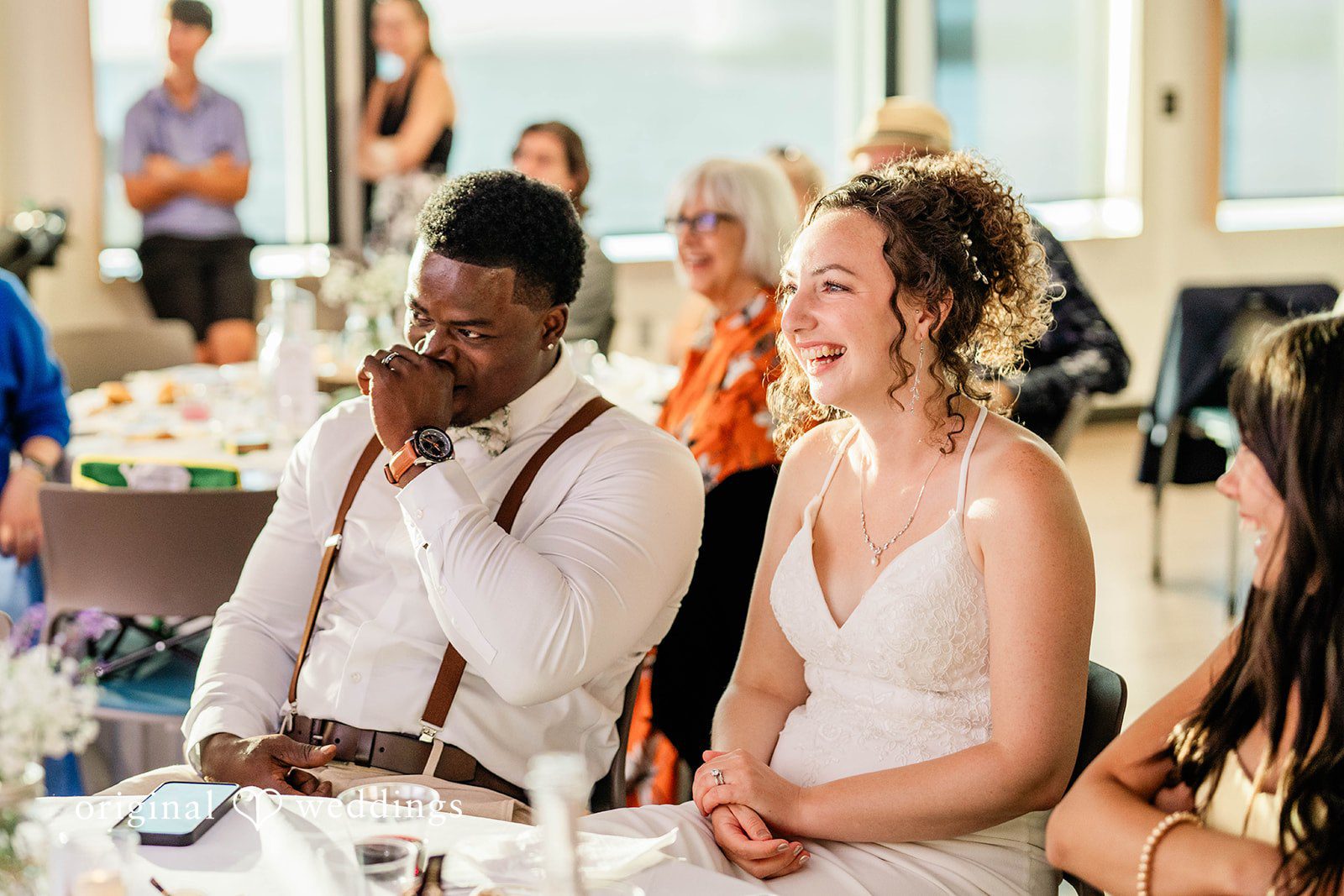 Naomi + Darrell Groom chatting with his bride and a guest during the wedding reception.