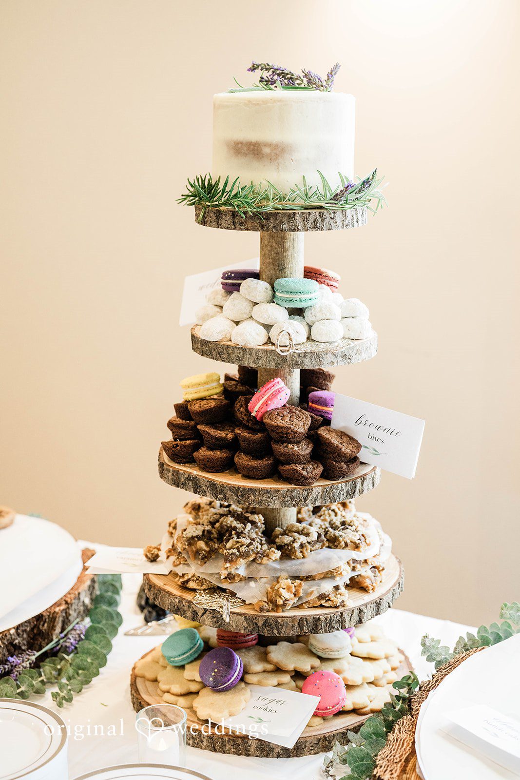 Naomi + Darrell Tiered wedding cake made of smaller pastries on a tall stand.