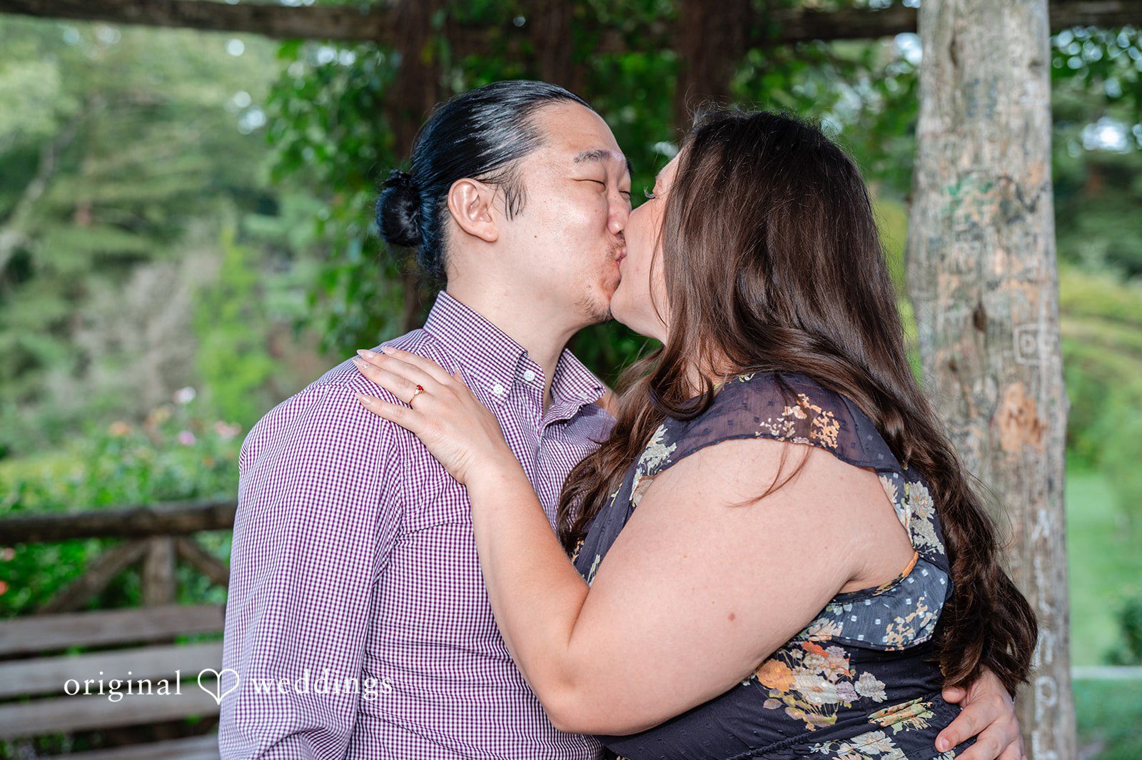 Gabrielle + James Close-up portrait of a couple kissing, with the man in a light purple dress shirt.