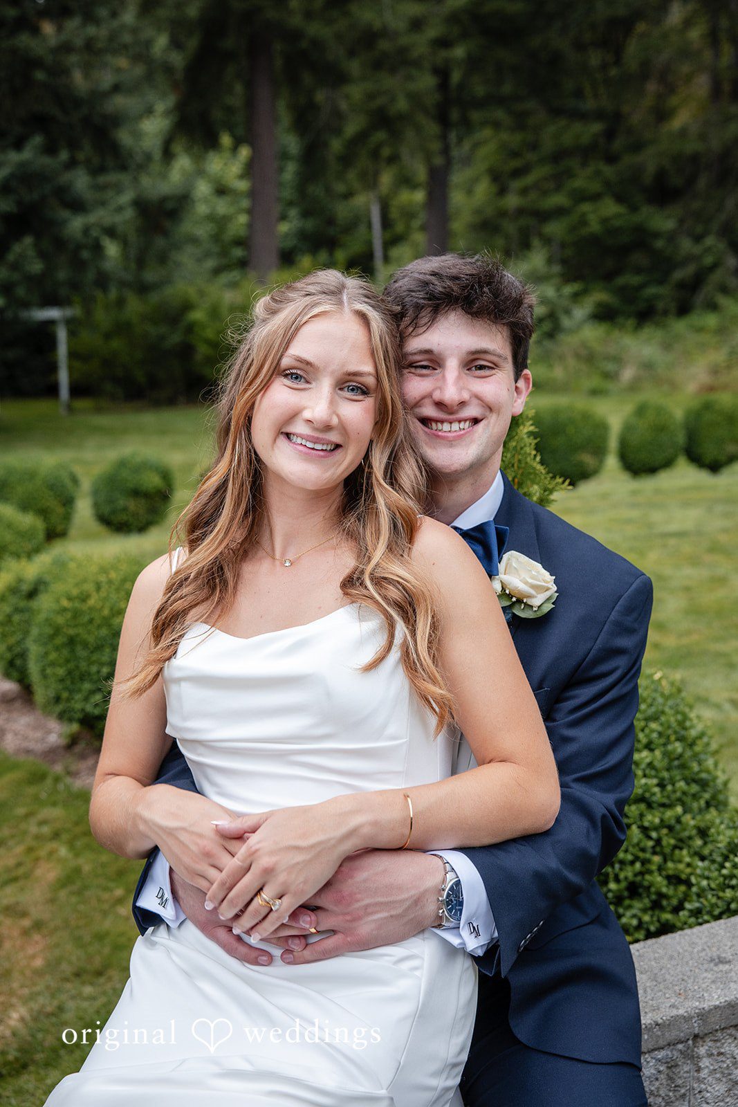 Alissa + Duncan A bride and groom posing closely together while smiling at the camera.