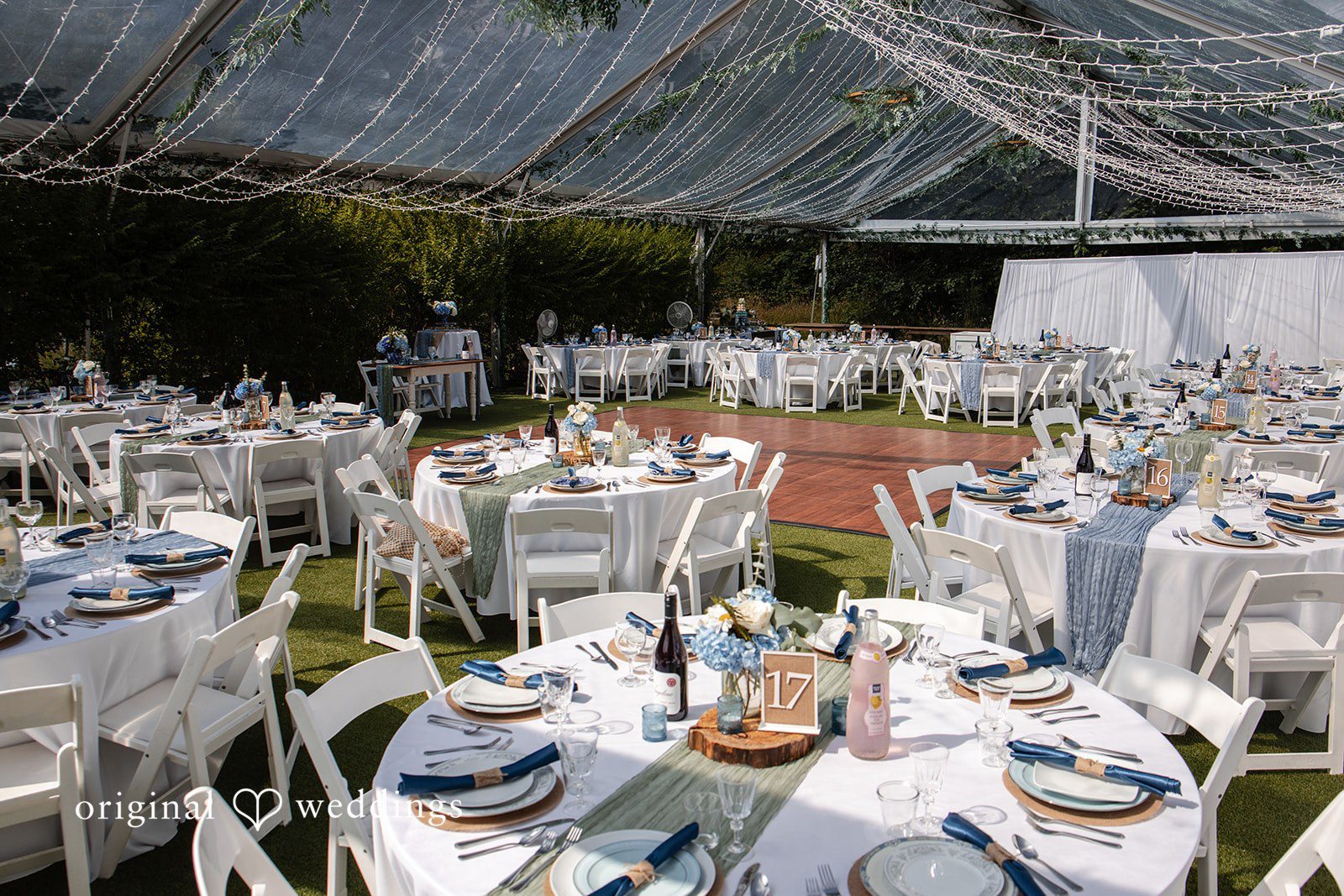 Alissa + Duncan An aerial view of round reception tables with white linens set up for a celebration.