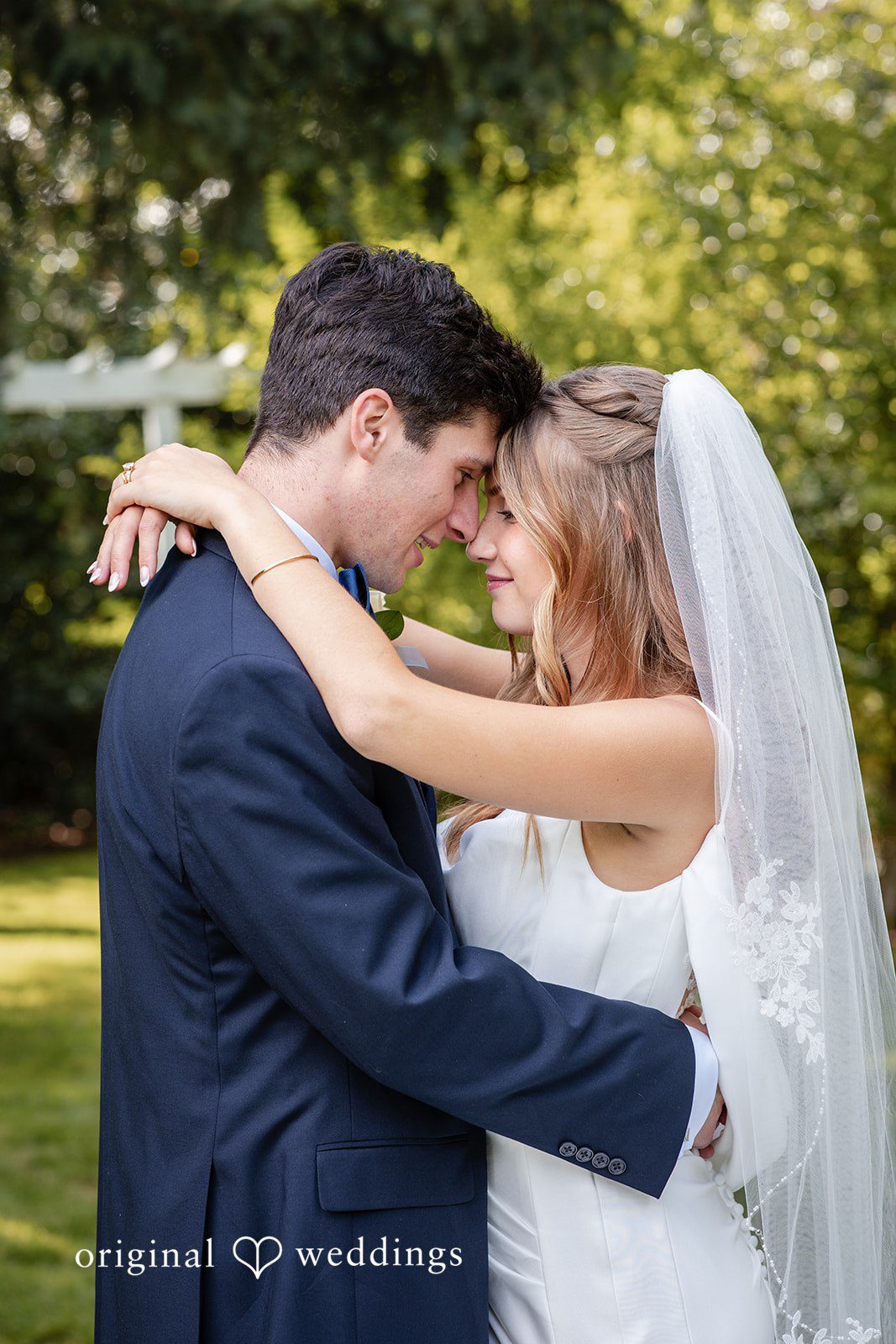 Alissa + Duncan A groom holding his bride close as she smiles happily.