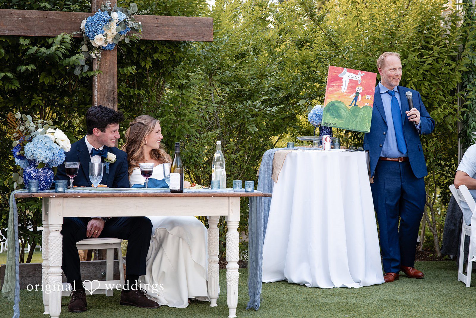 Alissa + Duncan A bride and groom interacting with guests near decorated reception tables.