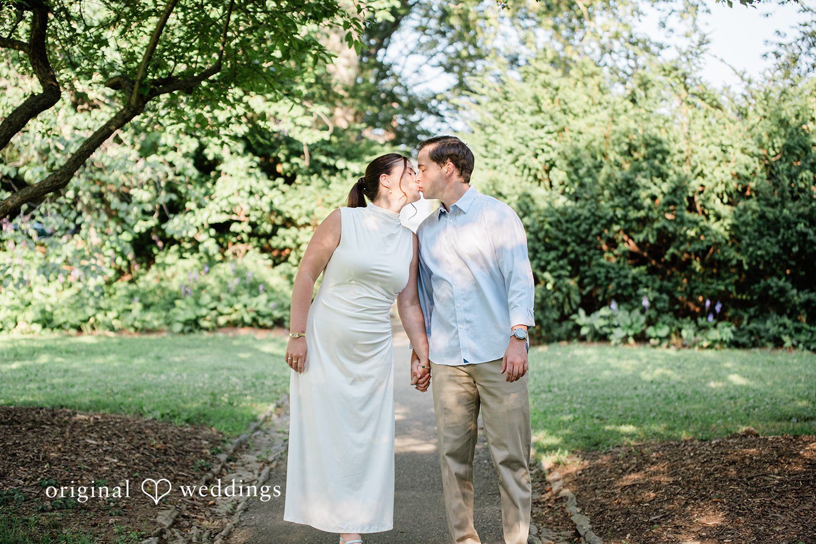 A couple standing close together and kissing each other.