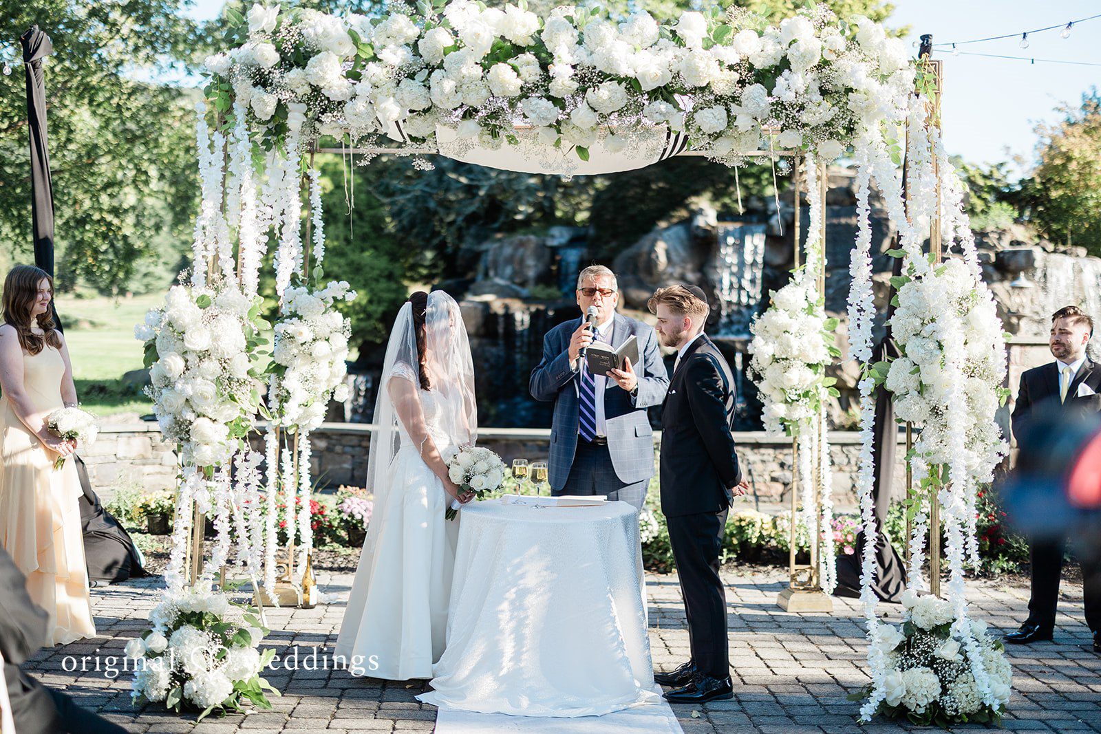 Julia + Camden A bride and groom standing together at the altar during their wedding ceremony.