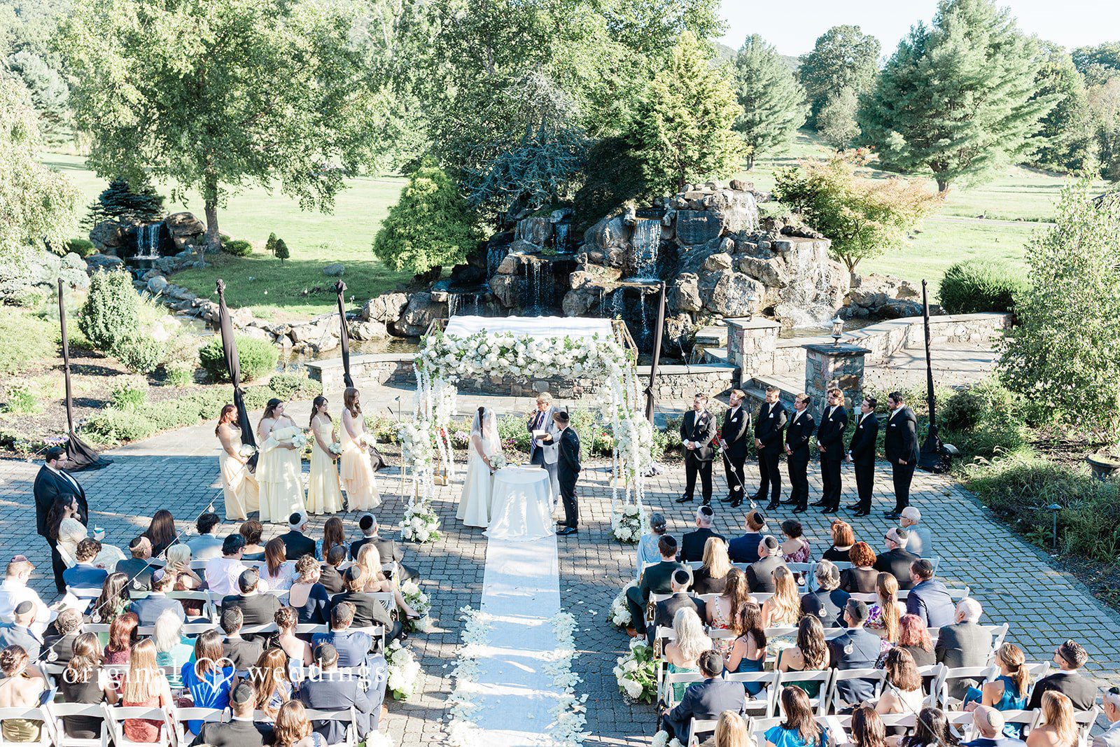 Julia + Camden A high-angle view of a wedding ceremony in progress with guests seated in rows.