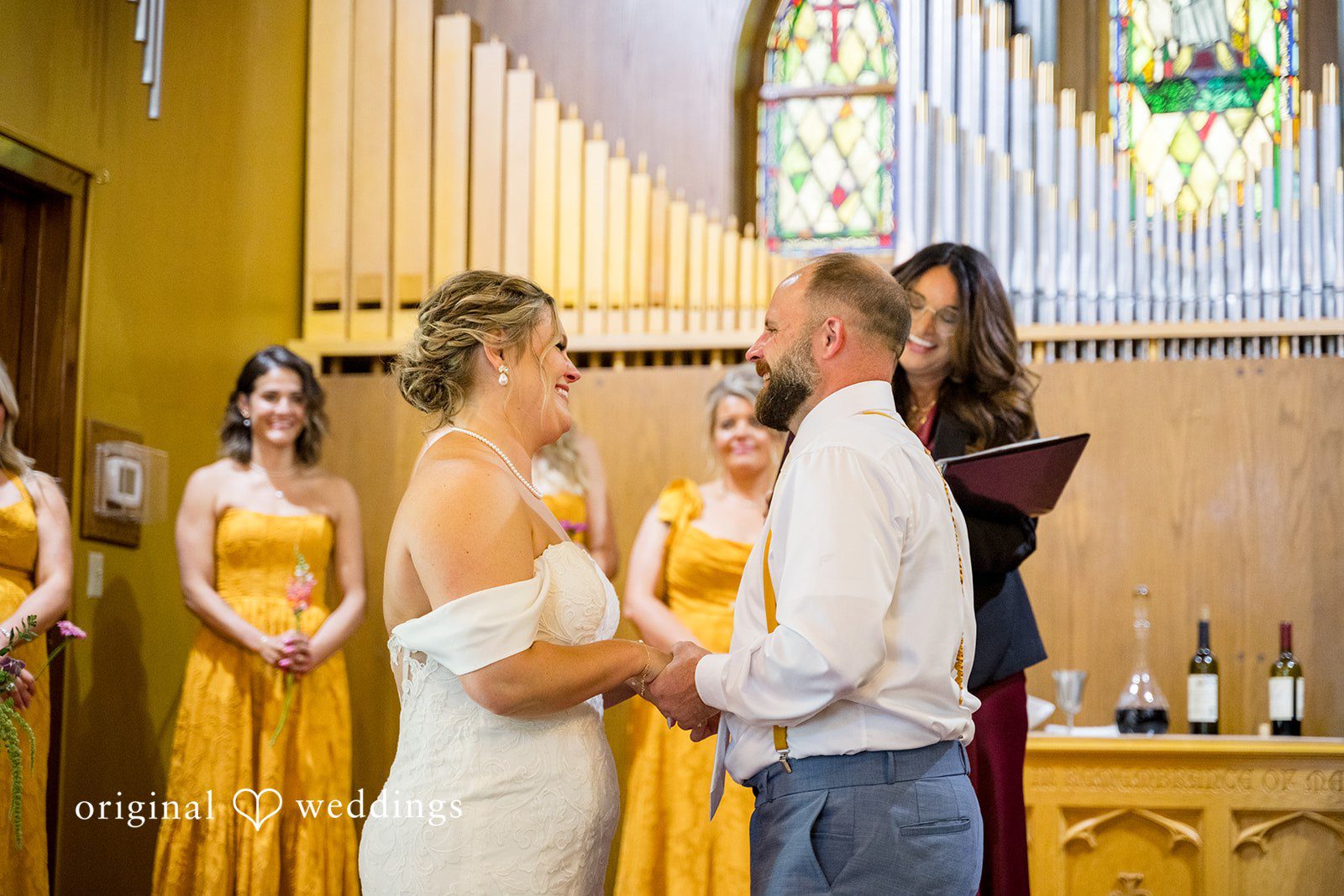 A bride and groom exchanging vows at the altar in front of a church congregation.