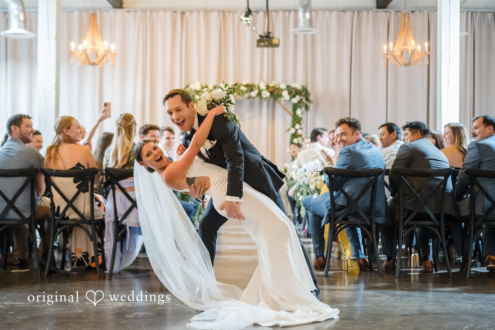 A bride and groom walking down the aisle together after getting married.